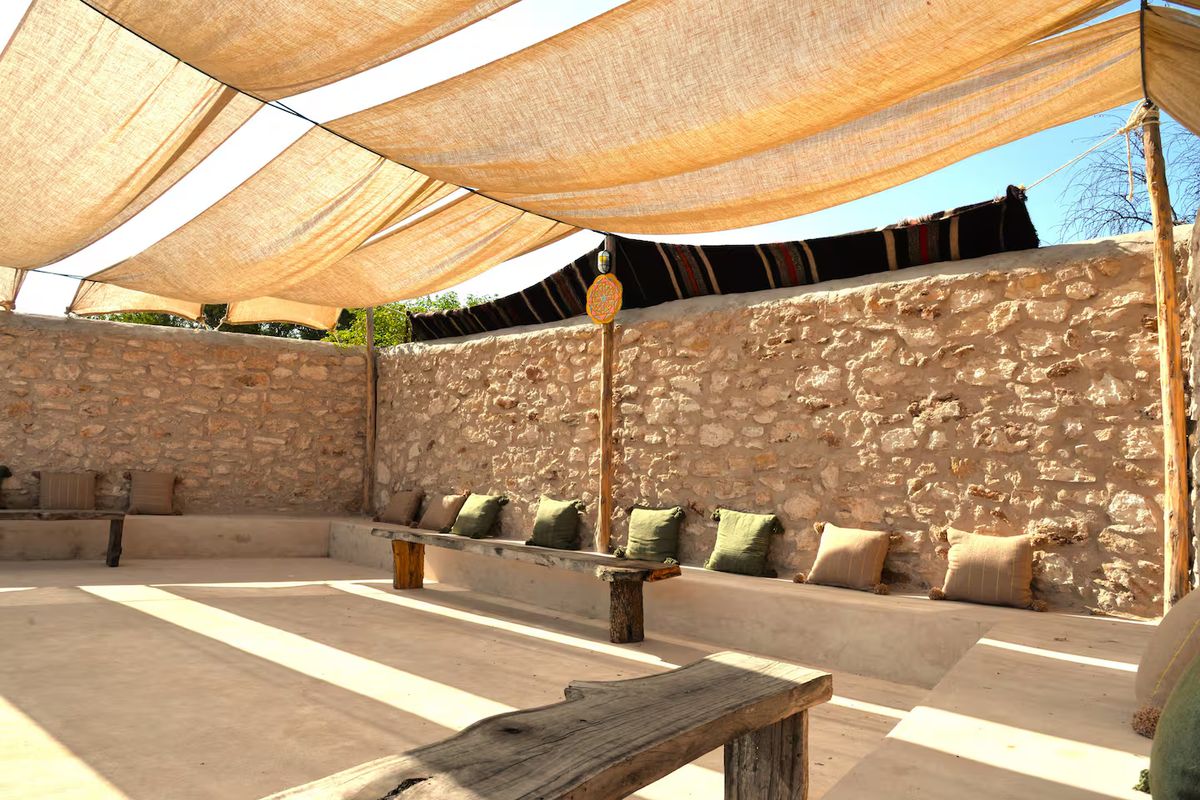 A shaded linen-canopied pergola at the villa